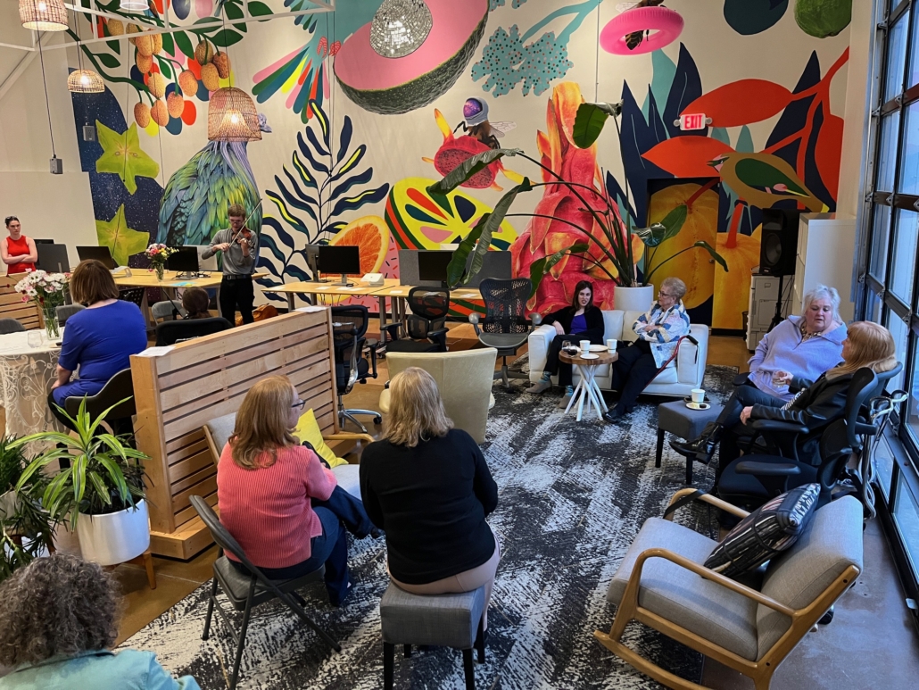 people watching a young man play violin